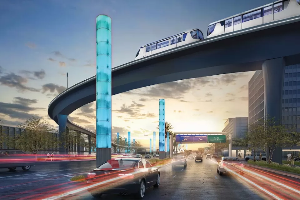 Rendering of automated people mover on elevated track at Los Angeles International Airport at nighttime with iconic light columns.
